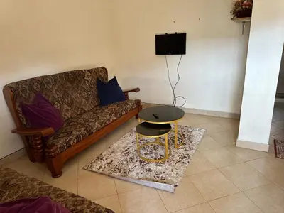 a living room with a couch and a table at Vicol luxe stay in Arusha