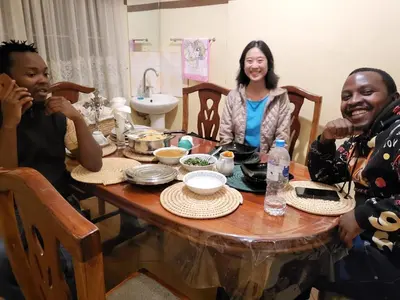 a group of three people sitting around a table at Msovi House in Arusha