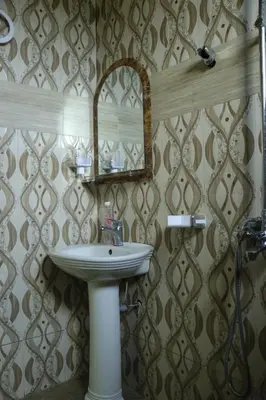 a bathroom with a sink and a mirror at MSOVI Nest in Arusha