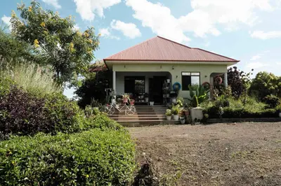a small white house with a red roof at MSOVI Nest in Arusha