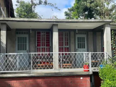 a screened in porch of a house with a fence at Makahawani Farmhouse in Arusha