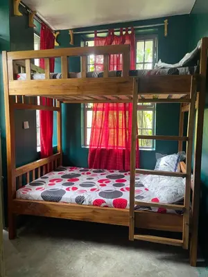 a bedroom with two bunk beds in a room at Makahawani Farmhouse in Arusha