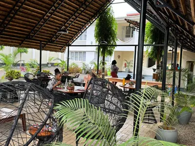 a group of people sitting at a table in a patio at Summit Retreat in Moshi