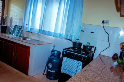 a kitchen with a stove and a counter top at Safari dwells apartment in Arusha