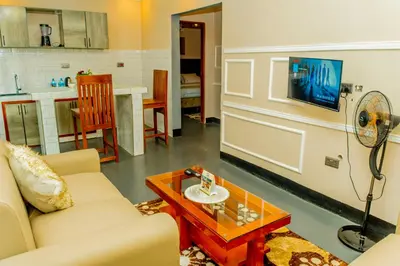 a living room with a couch and a table at Geni's Villa & Spa Arusha in Arusha