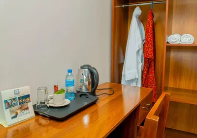a wooden table with a coffee maker on top of it at Geni's Villa & Spa Arusha in Arusha