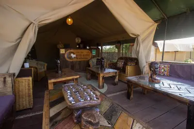 a tent with benches and tables in a room at Africa Safari Manyara Escarpment in Mto wa Mbu