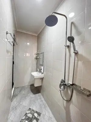 a bathroom with a shower and a sink at Hadraj Moshono Apartment2 in Arusha