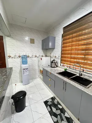 a kitchen with a sink and a refrigerator at Hadraj Moshono Apartment2 in Arusha