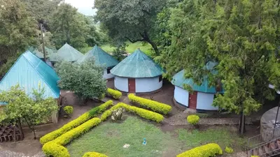 an overhead view of a garden with a group of huts at Emanyatta Lodge in Monduli