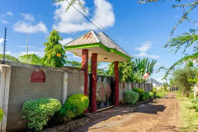 a small building with a roof on top of a wall at Rosemo villa in Nduruma Chini