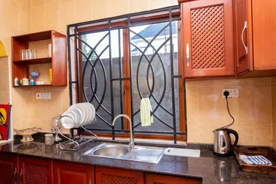 a kitchen counter with a sink and a window at Rosemo villa in Nduruma Chini