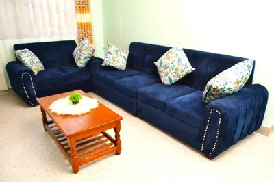 a blue couch and a coffee table in a living room at The Hill Villas House in Arusha