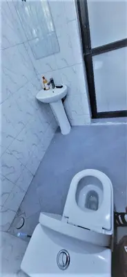 a bathroom with a toilet and a sink at The Hill Villas House in Arusha