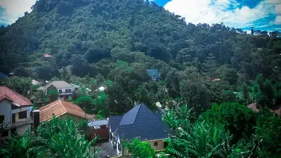 a village in front of a mountain at The Hill Villas House in Arusha