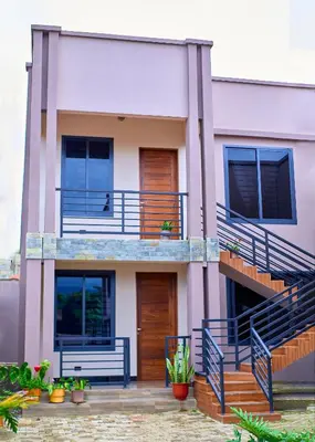 a house with blue balconies and stairs at Penthouse Moshono in Nkoanrua