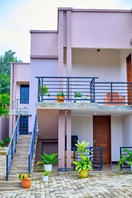 a building with stairs and potted plants on it at Penthouse Moshono in Nkoanrua