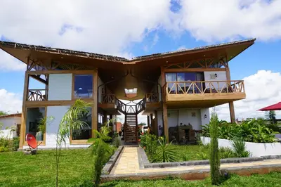 a house with a large roof at Moyoni Africa Lodge & Tours in Arusha