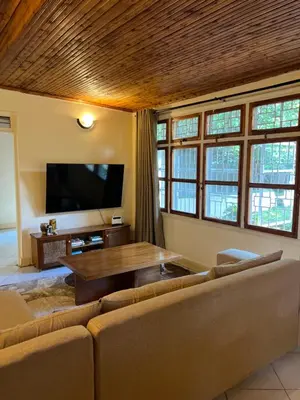a living room with a couch and a table at Nyani's hub in Moshi