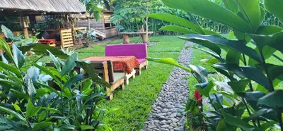a patio with two chairs and a table in a yard at Kidep Maasai Village in Moshi
