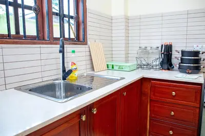 a kitchen with a sink and a counter at Oasis Homestay in Arusha