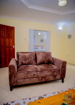 a couch sitting in a living room at Oasis Homestay in Arusha