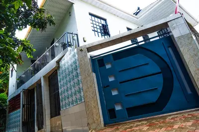 a blue garage door on the side of a house at Bienvenido a casa villa in Arusha