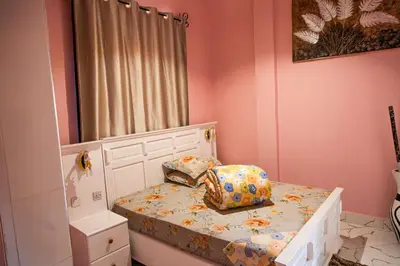 a small bedroom with a bed with a pillow on it at Bienvenido a casa villa in Arusha