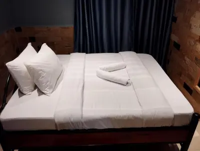 a white bed with a towel on top of it at Moonshine hotel in Themi