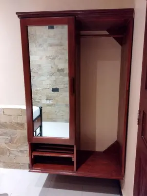 a mirror with a wooden frame in a room at Moonshine hotel in Themi