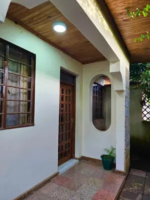 a front door of a house with a wooden ceiling at 2 bedrooms cozy house in Arusha in Arusha