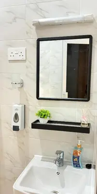 a bathroom with a sink and a mirror at Amaroz House in Nkunjila