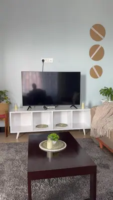 a living room with a tv and a coffee table at Amaroz House in Nkunjila
