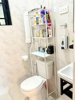 a bathroom with a white toilet and a sink at Amaroz House in Nkunjila