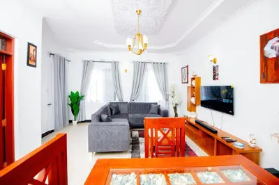 a living room with a couch and a table at Private Nest Apartment 2 in Arusha