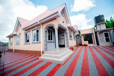 a house with a red carpet in front of it at Private Nest Apartment 2 in Arusha