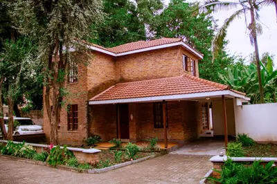 a small brick house with a roof at Fusion of Style & Comfort in Arusha