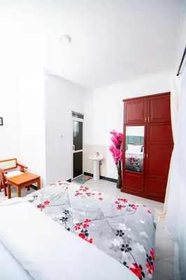 a bedroom with a bed and a red cabinet at Private Nest Apartment 2 in Nkoanrua