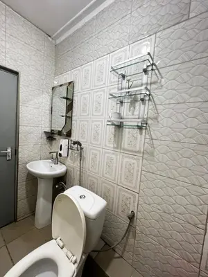 a bathroom with a toilet and a sink at Hadraj Sokokuu Apartment3 in Arusha