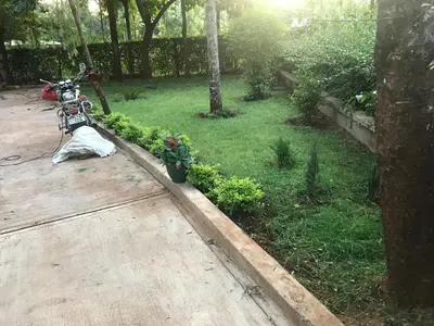 a garden with a motorcycle parked in a yard at Kitonga Escape in Msaranga