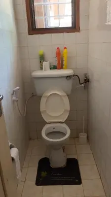 a small bathroom with a toilet with a window at Kitonga Escape in Msaranga