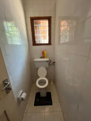 a small bathroom with a toilet and a window at Kitonga Escape in Msaranga