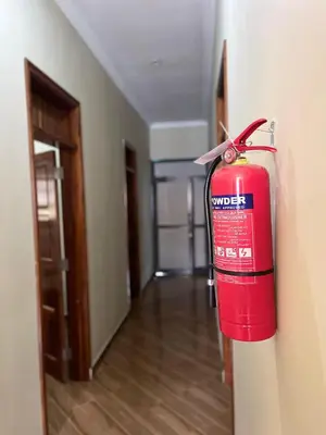 a fire extinguisher hanging on a wall in a room at R Kelly Tanzania in Arusha