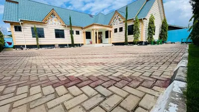 a brick driveway in front of a house at R Kelly Tanzania in Arusha