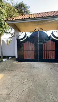 a garage with an open gate with an umbrella at Earth Villas in Arusha