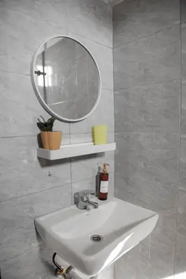 a bathroom with a sink and a mirror at Earth Villas in Arusha