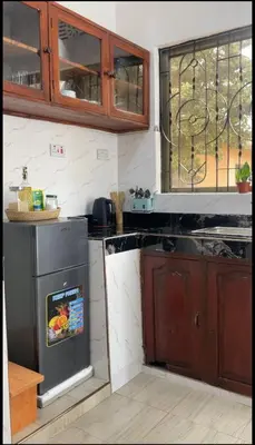 a kitchen with a sink and a stove top oven at Earth Villas in Arusha