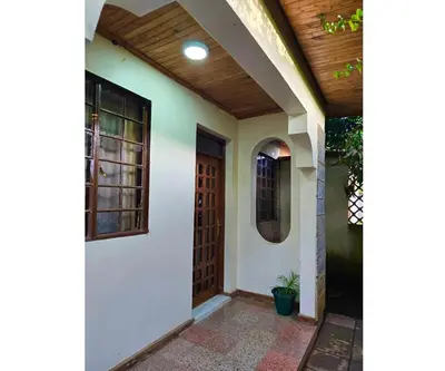 a front door of a house with a wooden ceiling at A private bedroom in a shared home in Arusha in Arusha
