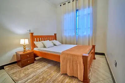 a bedroom with a bed and a window at Favourites home-English breakfast in Arusha