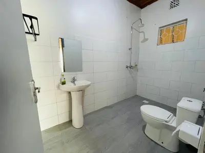 a bathroom with a toilet and a sink at Garden Villa Homestay in Arusha